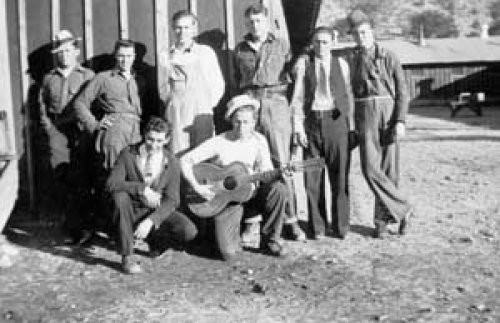 My Dad in CCC camp during the Great Depression. He’s the one with the guitar… and the hat…